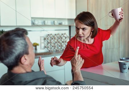 Stressed Wife. Concerned Stressed Wife Feeling Extremely Emotional While Cocking Her Husband With Cu
