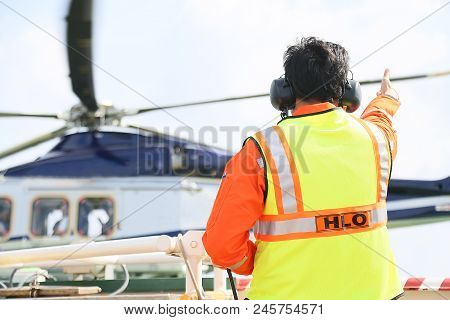 Helicopter Landing Officer Communicating With Pilot And Copilot For Service On Ground And Support As