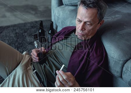 Stressed Man. Stressed Mature Man Feeling Extremely Thoughtful Being Alcohol And Cigarette Addicted