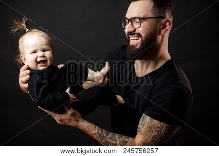 Loving Father Admires His Little Baby Daughter Holding Her On Hands
