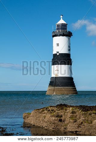 Trwyn Du Lighthouse Is A Lighthouse Between Black Point Near Penmon And Ynys Seriol, Or Puffin Islan