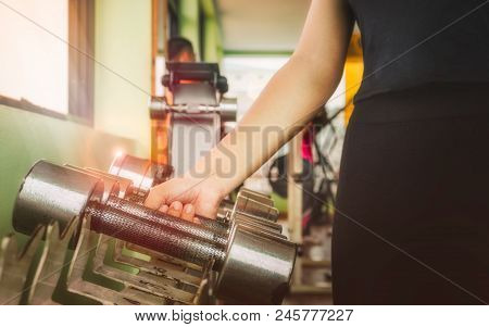 Hand Of Sports Woman Lifting Dumbbell For Weight Training Near Window By Right Hand For Pumping Bice