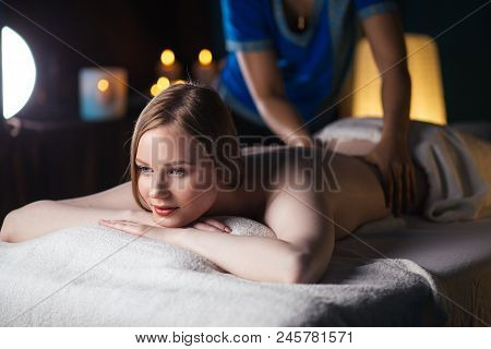 Serene Pleased Young Woman Enjoying Back Massage At Spa Center. Health Stress Treatment, Facial Skin
