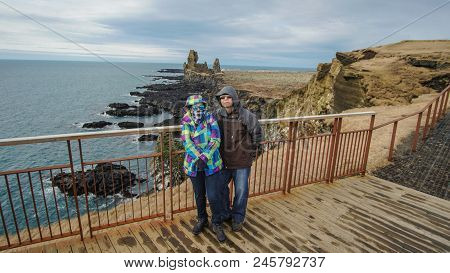 Asian Senior Couple Travel Photo With Iceland Pennisula Rock Landmark