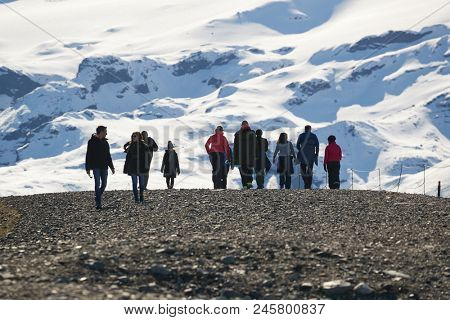 FJALLSARLON, ICELAND - MAY 2, 2018: Tourists walking at glacial lake FJallsarlon. The number of tourists in Iceland is on the rise for many years