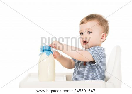 Adorable Baby Boy With Bottle Of Milk And Sitting Highchair Isolated On White Background