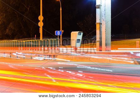 Stationary Car Speed Radar Near A Highway Road. Night Road Traffic Background