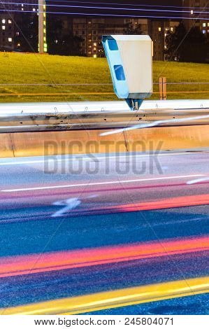 Stationary Car Speed Radar Near A Highway Road. Night Road Traffic Background