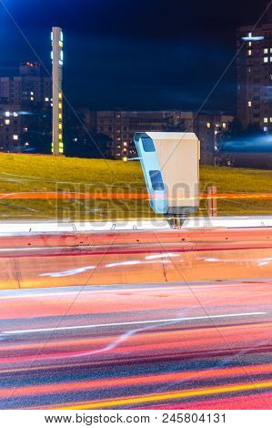 Stationary Car Speed Radar Near A Highway Road. Night Road Traffic Background
