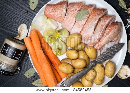 Fish Raw Snapper With Herb Spices For Fish In Glass Jar, Pepper, Bay Leaf, Celery On Dark Wood Backg