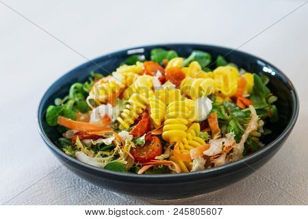Salad made from radiatori cooked pasta, goat cheese and oil vinaigrette