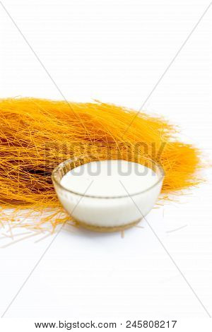 Close Up Of Raw Vermicelli Or Sevee Or Seviyan Or Seviyaan Isolated On White With A Bowl Of Milk Use