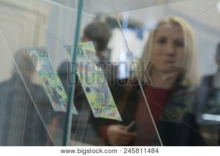 ST. PETERSBURG, RUSSIA - MAY 23, 2018: People at commemorative 100 rubles banknotes for FIFA World Cup Russia 2018 exposed in the exhibition 