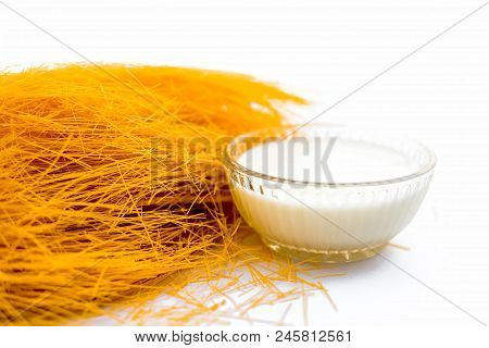 Close Up Of Raw Vermicelli Or Sevee Or Seviyan Or Seviyaan Isolated On White With A Bowl Of Milk Use