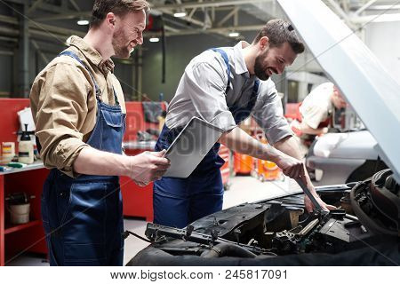 Portrait Handsome Of Two Workers Fixing Car In Service Workshop And Smiling Happily, Copy Space