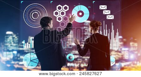 Two Business People Standing With Back And Working Together With Virtual Screen