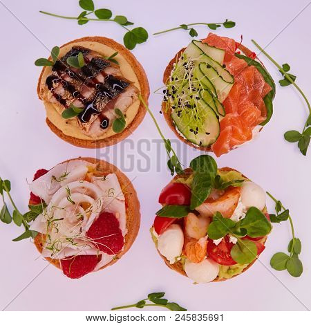 Four Different Toasts With Salmon, Mackerel, Shrimp And Halibut