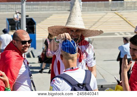 Football Fans Of Tunisia And England Are Changing Their Hats On The Fanfest Before The Match