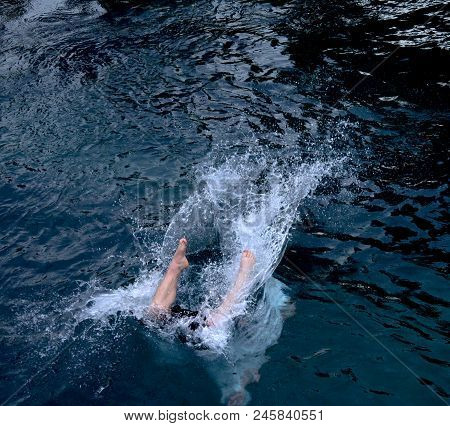 Legs Of A Man Into The Water After Jumping