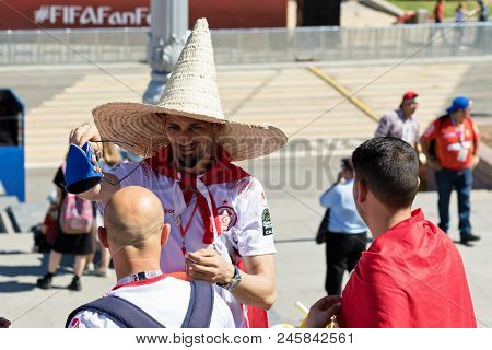 Football Fans Of Tunisia And England Are Changing Their Hats On The Fanfest Before The Match