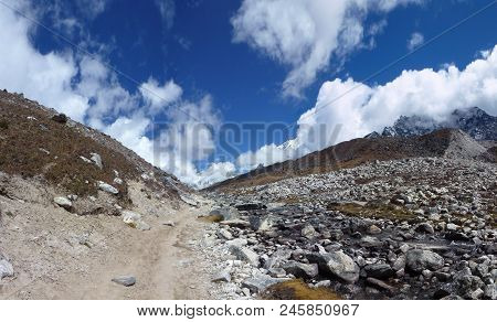 Trail In The Lobuche Valley With Big Clouds And Blue Sky, Everest Base Camp Trek, Nepal