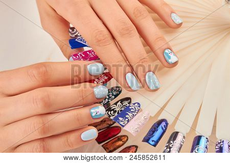 Well-groomed Hands With Beautiful Manicure. Young Woman Hands With Winter Design Manicure Holding Na