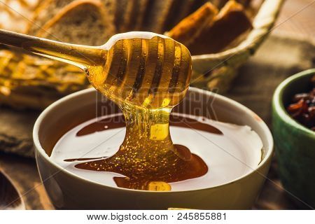 Wooden Honey Dripper Spoon Close Up With Stretching Honey, Macro Shot