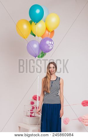 Studio Portrait Of An Attractive Girl Waiting For Her Birthday. Face And Balloons