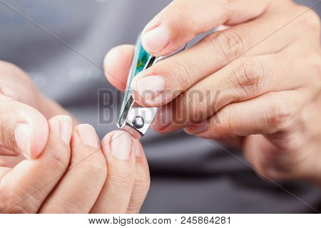 Male Hands Cutting Finger Nails One Another