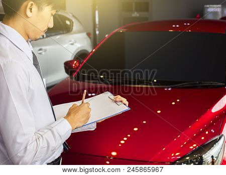 Career Man Saleman Business Inspection Writing On Notepad Or Book, 
Paper With Car Blurry Background