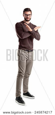 A Fashionable Man In Glasses And Casual Clothes Stands Half-turned With Hands Making A Cross In Fron