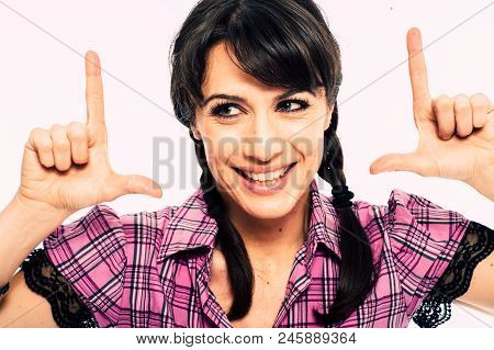 Young Caucasian Brunette Holding A Fake Tv Set Top Box. Promo. White Background Studio Shot. Pink Sh