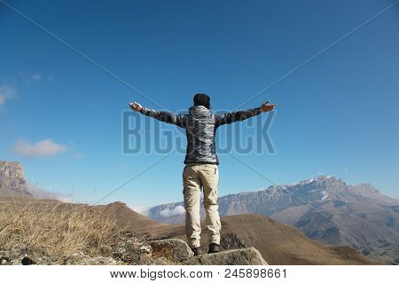 An Applause Of A Young Woman Backpacker On Top Of A Sprawling Upward Mountain Peak. Freedom And Vict