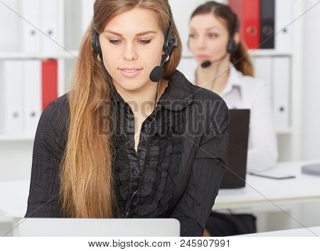Portrait Of A Beautiful Female Caucasian Call Center Wokers With Handset.