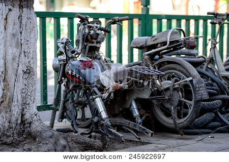 Beijing, China - March 10, 2016: Bicycles, Scooters And Cars In Beijing Streets.  The Street Side Of