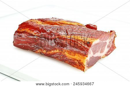 A Piece Of Meat Balyk With A Crust Of Spices And Sesame Seeds On A Cutting Board