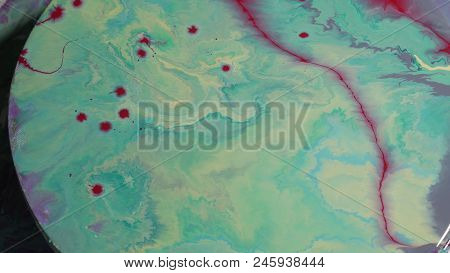 Painted Round Canvas In Green In Fluid Art Style