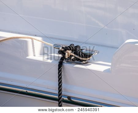 Dock Cleat On The Side Of A Boat In A Small Marina, An Element Of Yachting Equipment