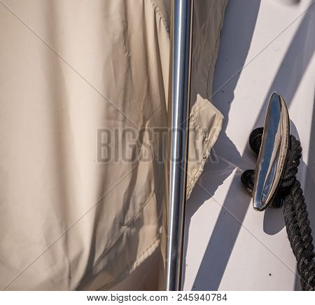 Dock Cleat On The Side Of A Boat In A Small Marina, An Element Of Yachting Equipment