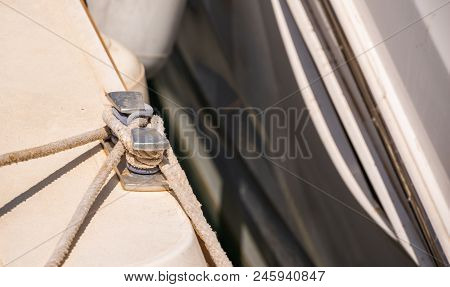 Dock Cleat On The Side Of A Boat In A Small Marina, An Element Of Yachting Equipment