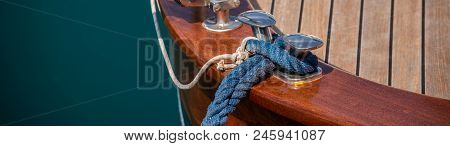 Dock Cleat On The Side Of A Boat In A Small Marina, An Element Of Yachting Equipment