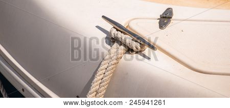 Dock Cleat On The Side Of A Boat In A Small Marina, An Element Of Yachting Equipment