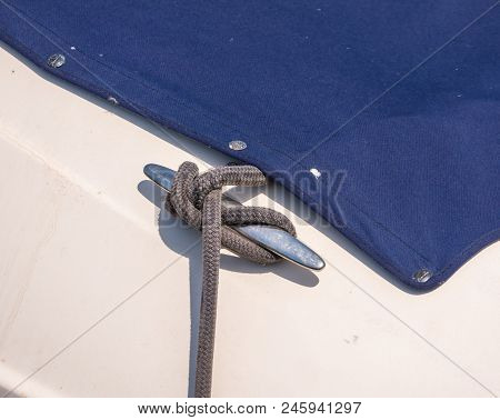 Dock Cleat On The Side Of A Boat In A Small Marina, An Element Of Yachting Equipment