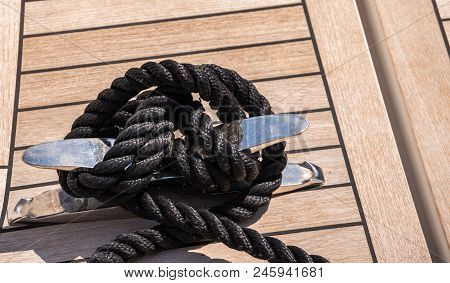 Dock Cleat On The Side Of A Boat In A Small Marina, An Element Of Yachting Equipment