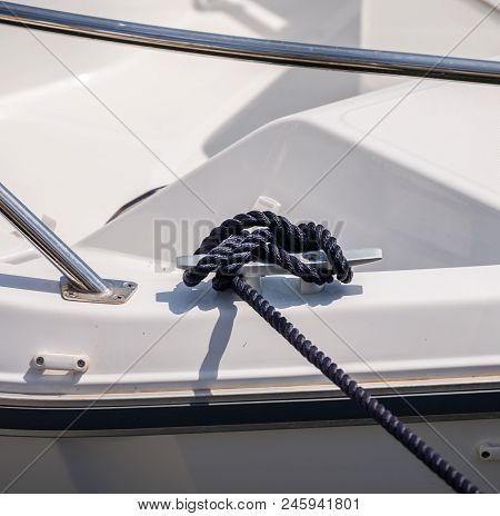 Dock Cleat On The Side Of A Boat In A Small Marina, An Element Of Yachting Equipment