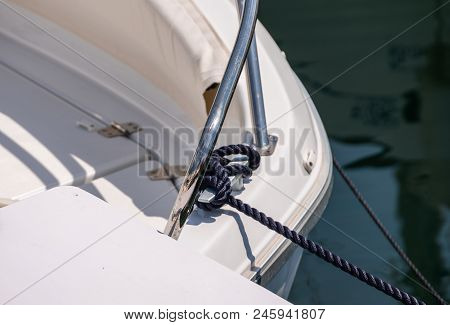 Dock Cleat On The Side Of A Boat In A Small Marina, An Element Of Yachting Equipment
