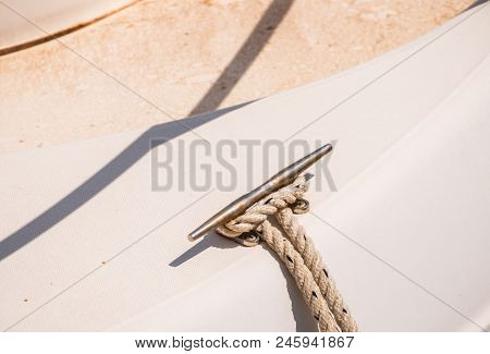 Dock Cleat On The Side Of A Boat In A Small Marina, An Element Of Yachting Equipment
