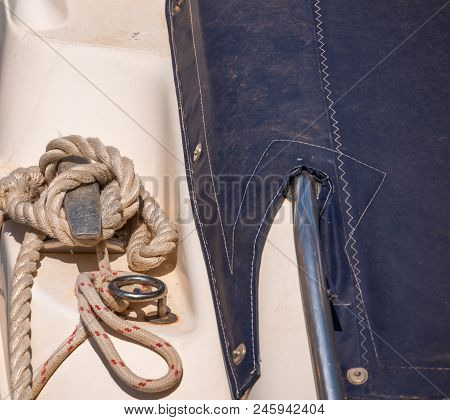 Dock Cleat On The Side Of A Boat In A Small Marina, An Element Of Yachting Equipment
