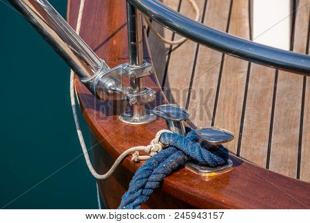 Dock Cleat On The Side Of A Boat In A Small Marina, An Element Of Yachting Equipment