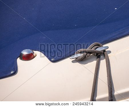 Dock Cleat On The Side Of A Boat In A Small Marina, An Element Of Yachting Equipment